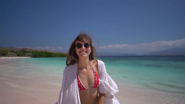 Close Up of Smiling Young Female in White Tunic Outdoors Girl Runs on the Beach Turning to the