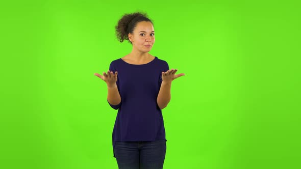 Curly Woman Is Upset, Waving Her Hands in Indignation. Green Screen