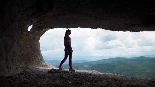 Girl Traveler Walks Through Cavern