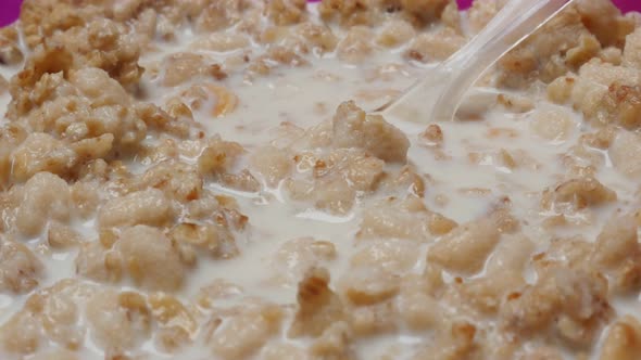Corn flakes and rice in the muesli mix with milk 4K 2160p 30fps UltraHD  tilting footage - Tasty bre