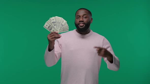 Rich Afro American Man in Casual Holding Money and Wink on Green Screen Chroma Key