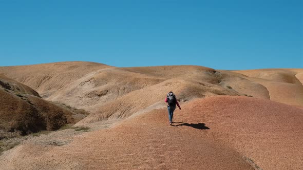 Female Backpacker Hiking on Hills in Steppe