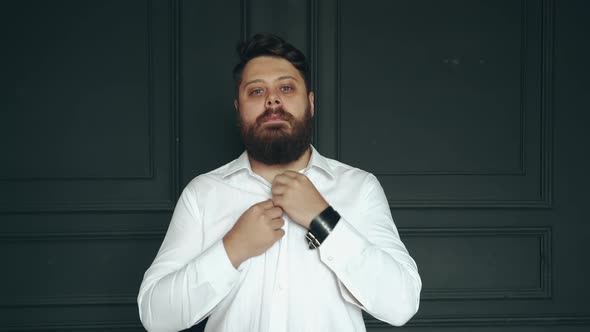 Gentleman posing in studio. Portrait of stylish handsome man with beard in studio