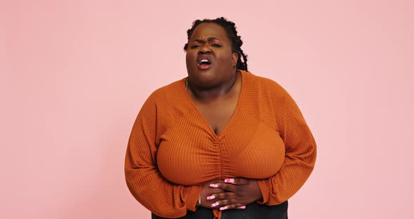 Black Woman Shows Abdominal Pain Using Facial Expression