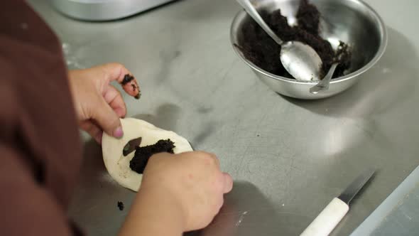 Cooking. Bakery Products. Close-up. Woman Baker Makes, Sculpts Pies, Buns with Poppy Seeds. Health