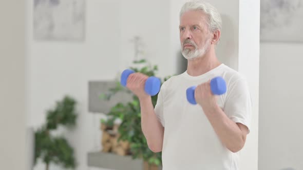 Close Up of Loving Old Man Doing Exercise with Dumbbells