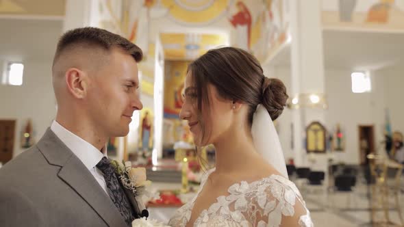 Lovely Family Newlyweds Couple Bride Embracing Groom in an Old Church Wedding Ceremony Matrimony