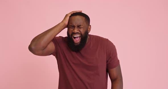 Young African American Man Scream Got Headache Isolated on Pink Background
