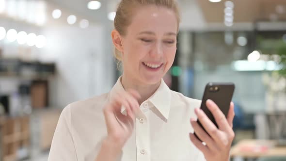 Portrait of Young Businesswoman Doing Video Call on Smartphone