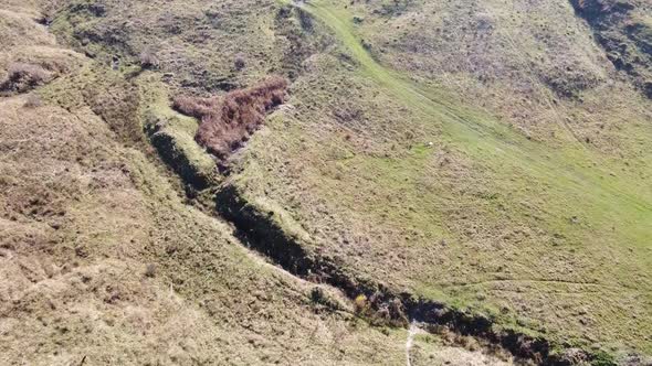 Aerial view of country hills at sunset in autumn season. Beautiful rural scene with dead nature, ear