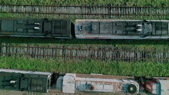 Aerial Top Down Shot of an Abandoned Rusty Locomotives and Old Railways