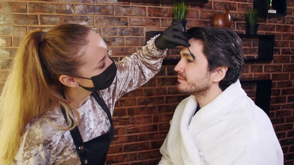 Young Stylish Man in a Beauty Salon. Face and Eyebrow Care