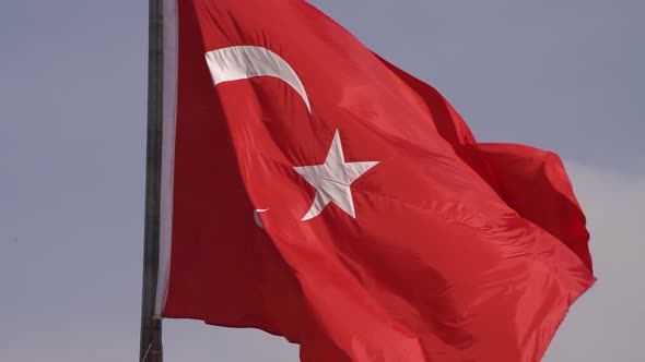 Turkey Red Flag with Crescent and Star Signs at Sunlight