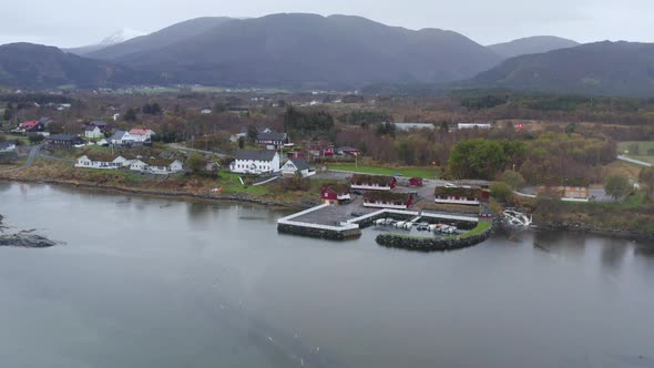 Small Jetty At The Coast Of Norwegian Sea With The Atlantic Road Cabins In Averoy, Norway. - aerial