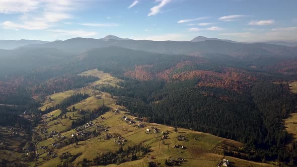 Aerial view of autumn mountain landscape with evergreen pine trees and yellow fall forest with