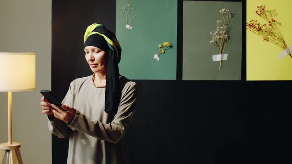 Woman in Turban Using Smartphone