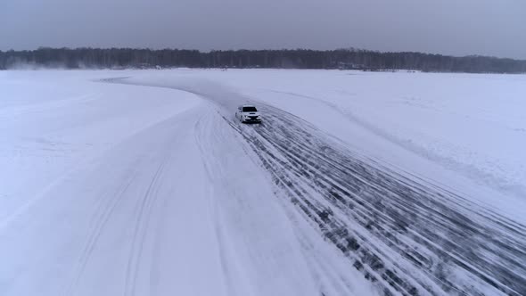 Aerial view of the rally car on a snowy road