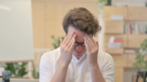 Portrait of Young Man Having Headache