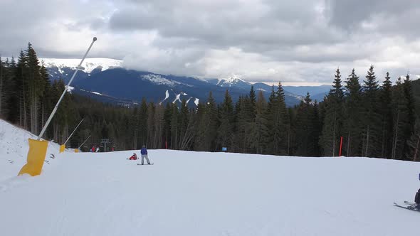 People skiing on the snowy slope of Bukovel ski resort in the Ukrainian Carpathian mountains.