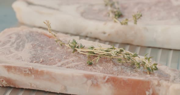 Close up slow motion shot of meat on a grilling plate in an outdoor luxury litchen