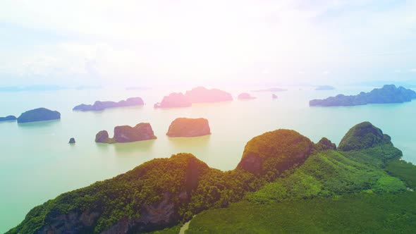 Aerial view from a drone over many islands at Phang Nga Bay during sunset time