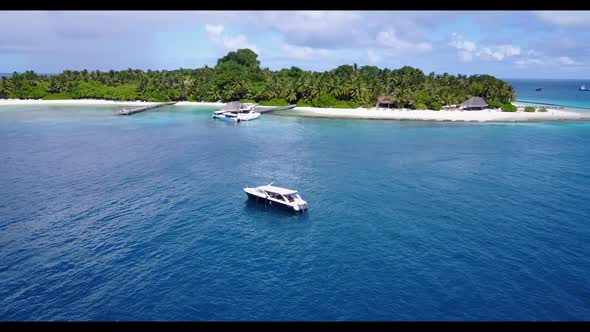 Aerial landscape of paradise coastline beach lifestyle by clear lagoon with white sand background of