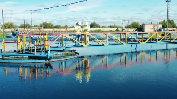 Two Wastewater Operators Monitoring a Sewage Treatment Plant