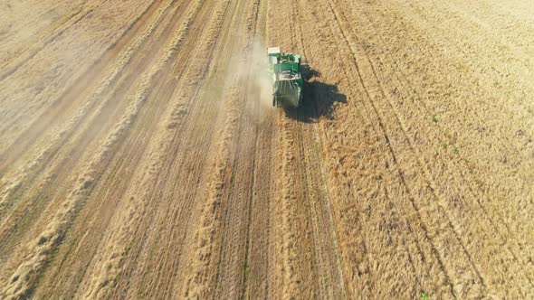 Aerial View of Combine Harvester on Wheat Field