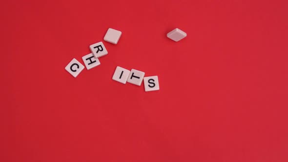 White letter tiles moving to spell out christmas on red background