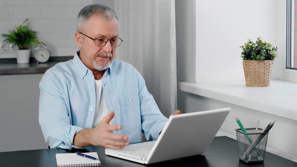 Older Man Feels Rage As He Looks at the Laptop Screen