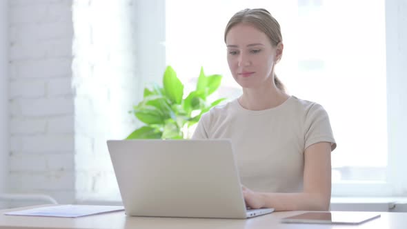 Thumbs Down By Woman Working on Laptop