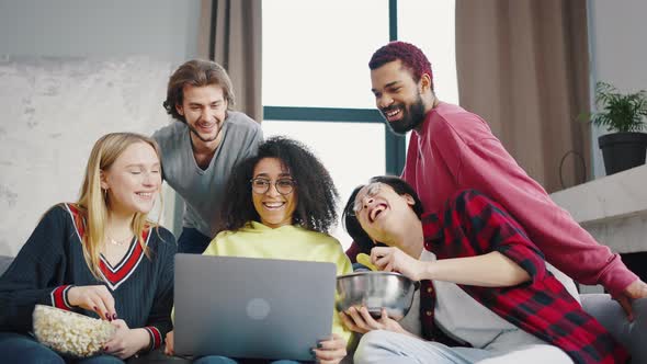 Cheerful Company of Students Has a Video Call Using a Laptop