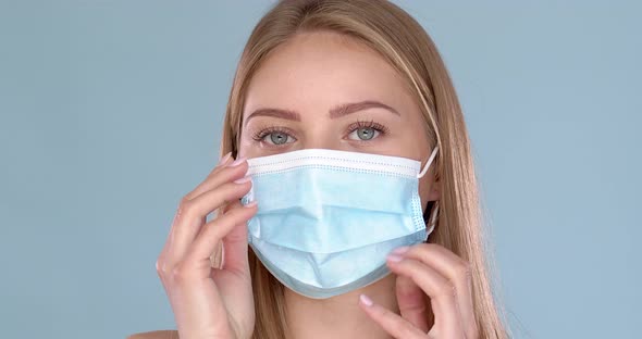 Young Woman Adjusting Her Medical Face Mask