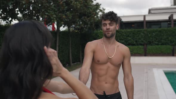 Couple Hugging By the Pool