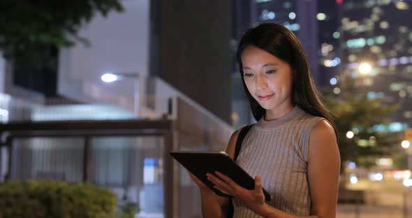 Woman use of tablet computer at night 