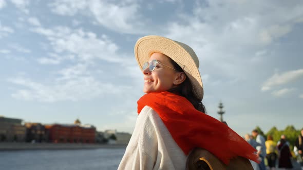 Beautiful woman with a red scarf in a european city in summer