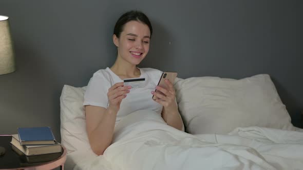 Online Payment Success on Smartphone By Young Woman in Bed 