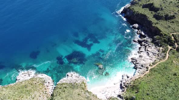 Stunning bay with crystal clear turquoise water at Zingaro on the island of Sicily in Italy, sunny w