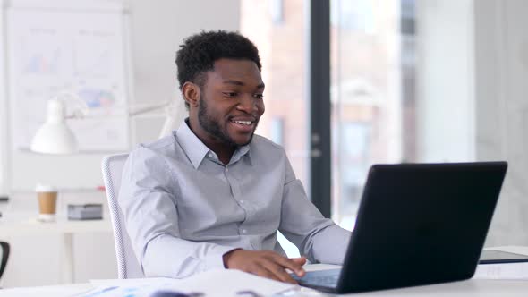 Businessman Having Video Chat on Laptop at Office