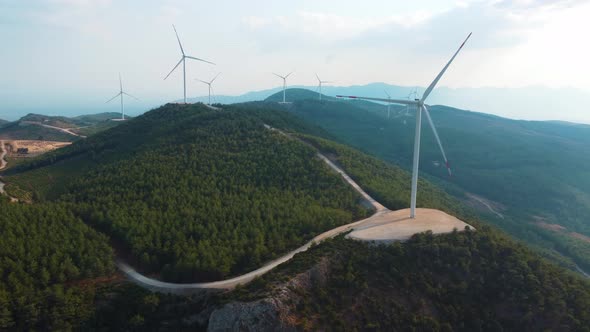 The windmills at the top of the hill generate clean green energy.