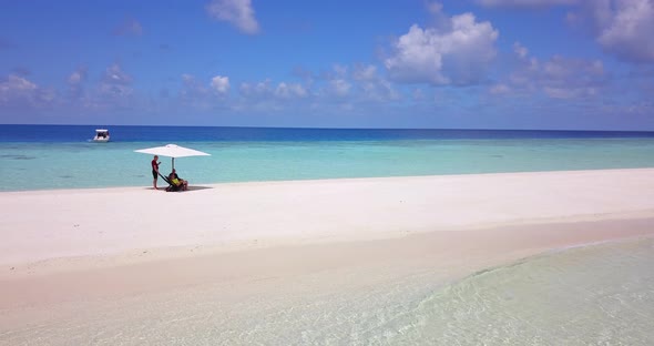 Young man and woman on romantic honeymoon spend quality time on beach on sunny white sandy backgroun