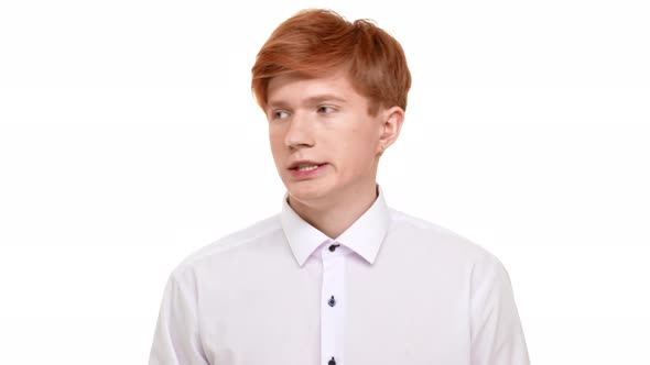 Nervous Ginger Caucasian Young Boy Standing on White Background Shuffling Around