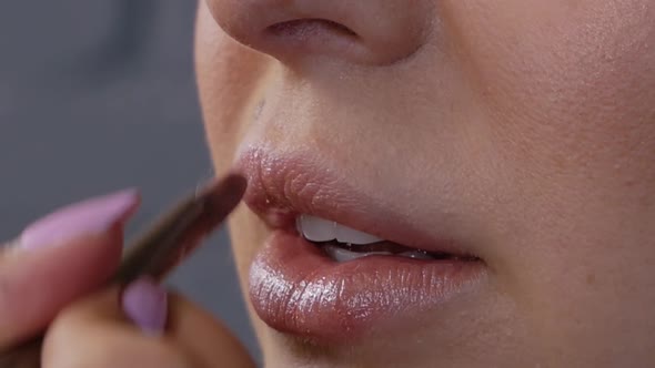 Makeup Artist Applying Lipstick