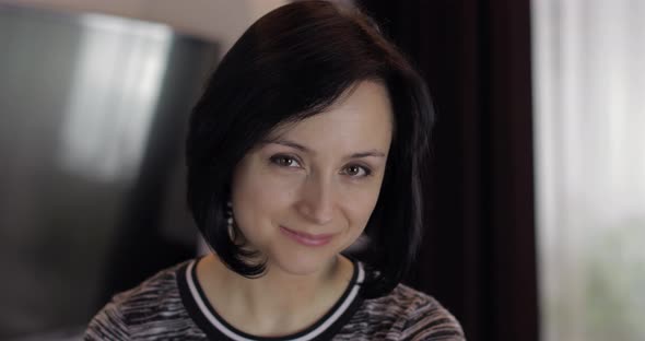 Portrait of Pretty Caucasian Young Brunette Woman Smiling at Home