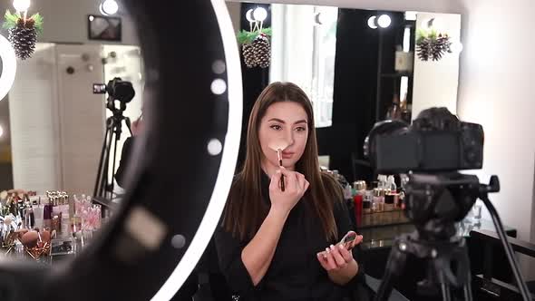 Profession Make Up Artist Woman Reviewing Beauty Products on a Video Blog at Beauty Studio