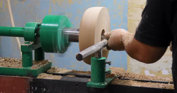 Closeup of carpenter turning wood on a lathe