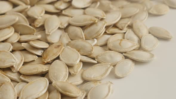 Pile of  healthy pumpkin seed slow pan 4K 2160p 30fps UltraHD footage - Pepitas ready to be roasted 