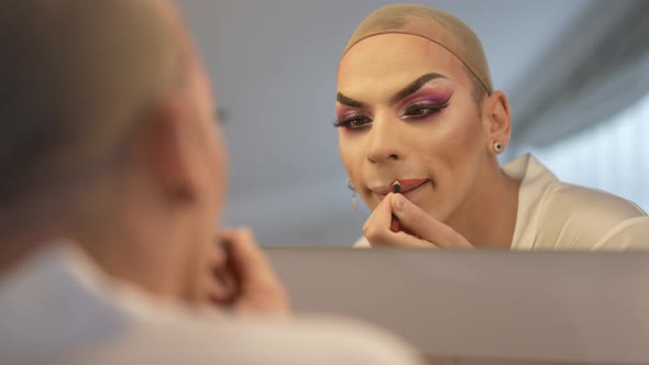 Reflection in Mirror Focused LGBT Genderfluid Woman Painting with Lip Pencil in Slow Motion