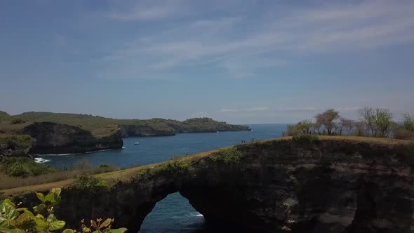 Smooth aerial view flight drone shot of instagram influencer spot Broken Beach at Nusa Penida in Ba