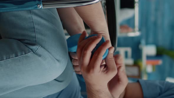 Vertical Video Close Up of Disabled Woman Using Dumbbells for Recovery